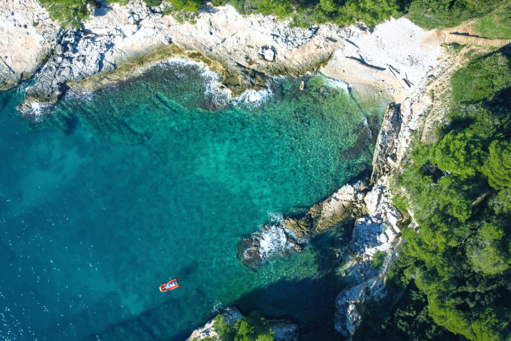 aerial view of a secluded bay with tourqouise waters and small beach