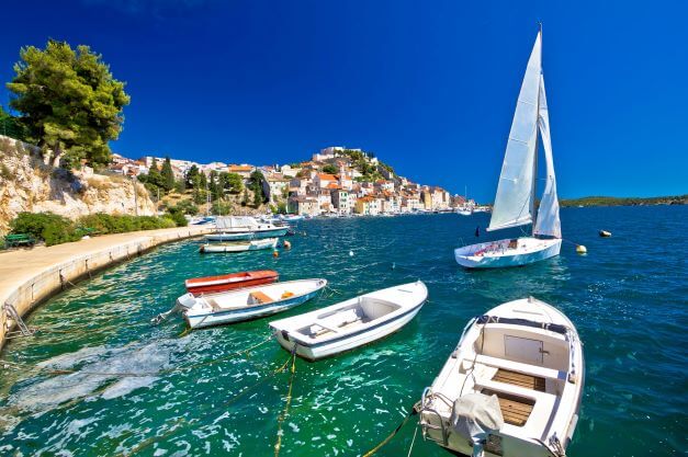 small boats anchored in front of the fisherman village