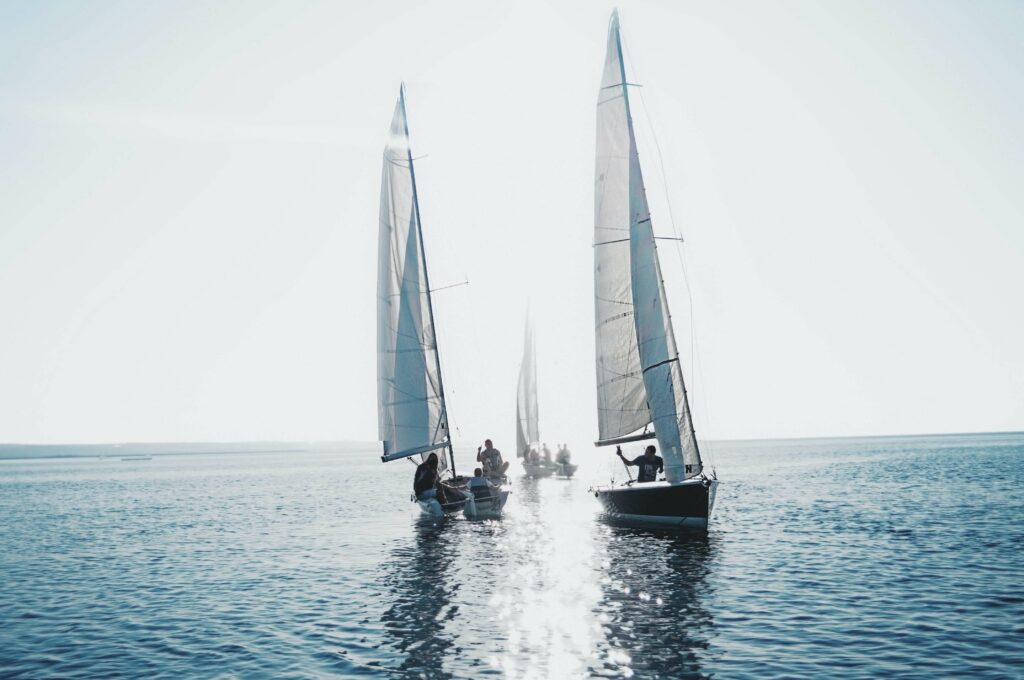 families on small sailing boats having fun