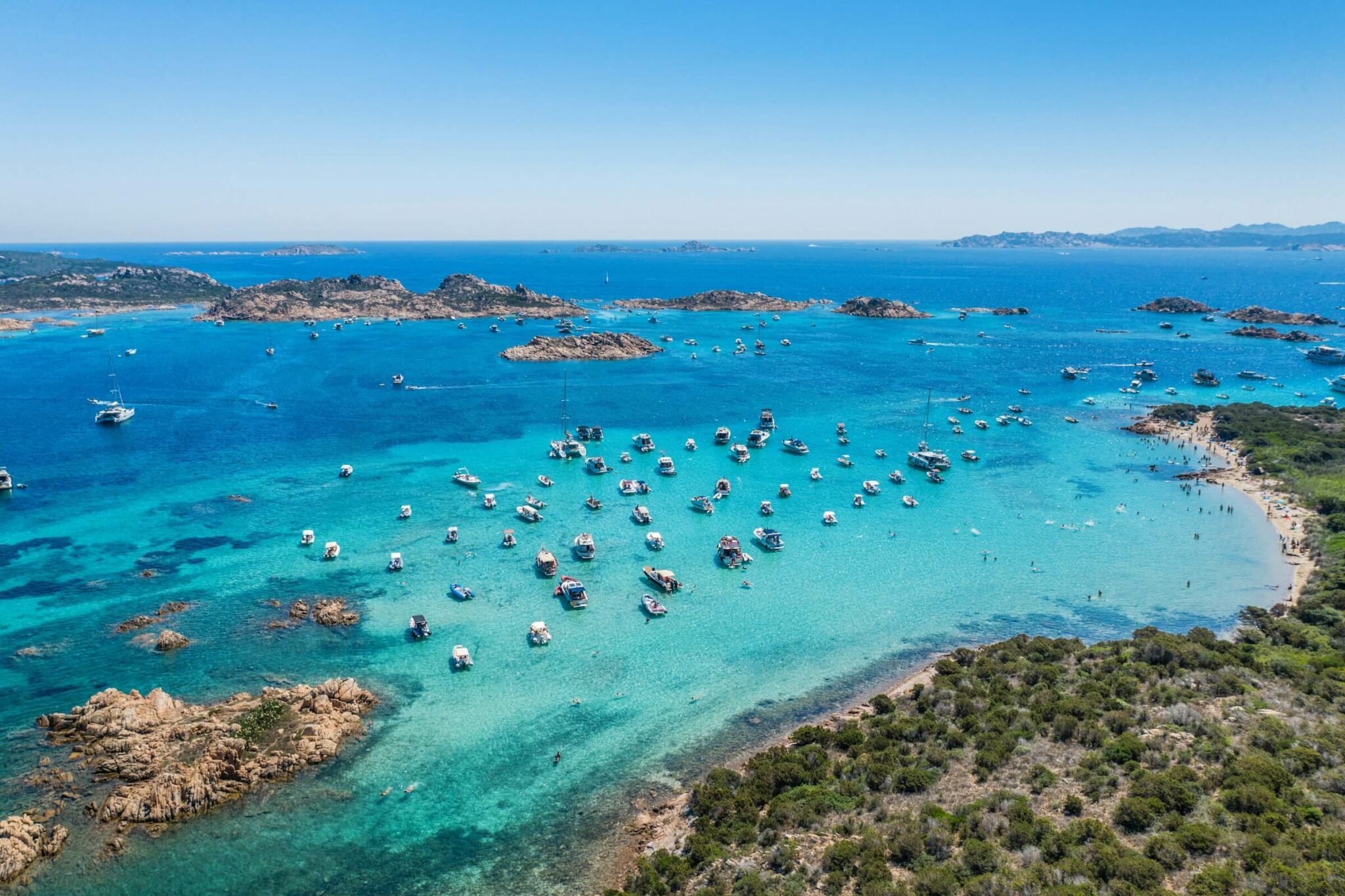 many boats anchored in a bay in Sardinia