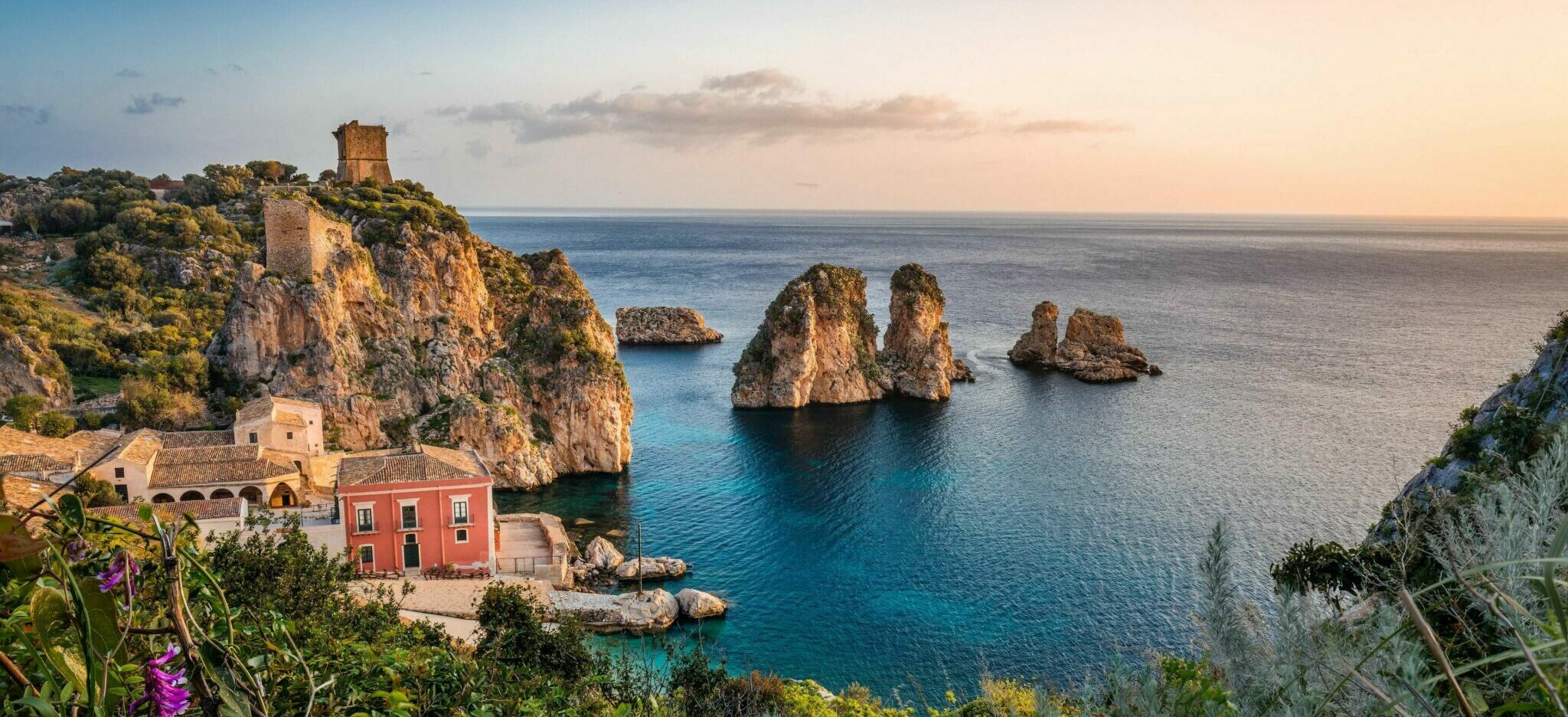 rock formations and a house at the shore