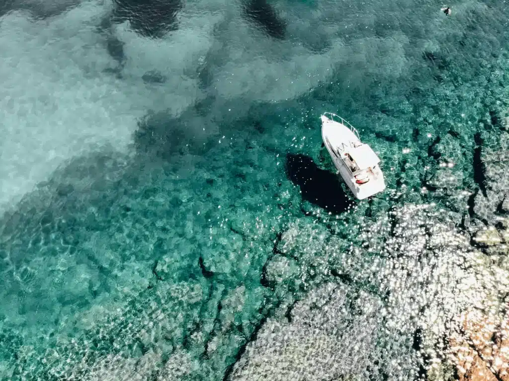 boat anchored in clear waters 