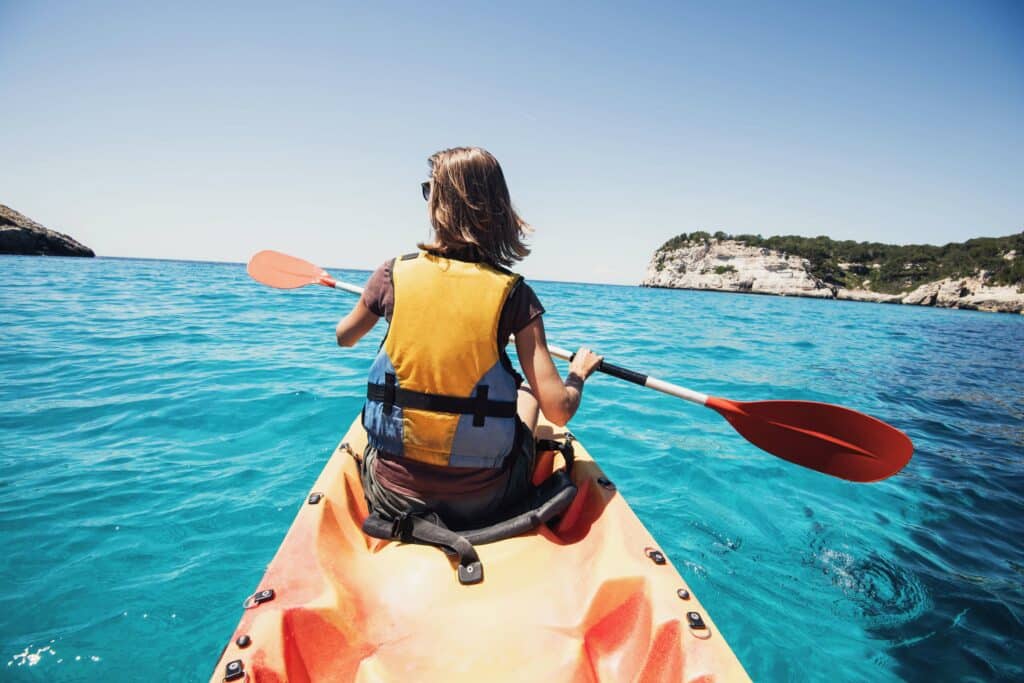 woman on kayak wearing life jacket